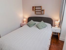 A bedroom with a bed and nightstands at The Secret Garden in Narberth