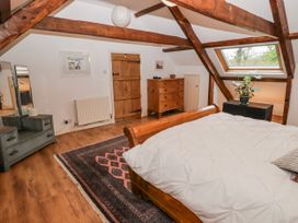 A bedroom with a bed and a chest of drawers at The Secret Garden in Narberth