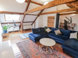 A living room with a blue sofa and telescope at The Secret Garden in Narberth