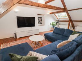 A living room with a television and a sofa at The Secret Garden in Narberth