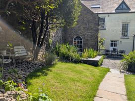 A garden with chairs and a pathway at The Secret Garden in Narberth
