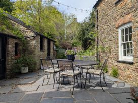 A patio area with a table and chairs at The Secret Garden in Narberth