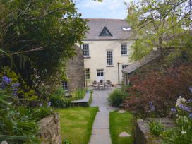 A garden with a house in the background at The Secret Garden in Narberth