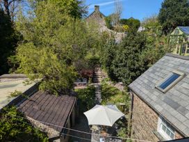 A garden with a pathway and outdoor seating area at The Secret Garden in Narberth