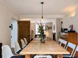 A dining room with a wooden table and chairs at The Secret Garden in Narberth