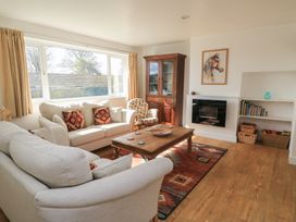 A living room with a sofa and coffee table at 11 Berry Close Painswick