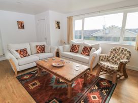 A living room with seating and a coffee table at 11 Berry Close in Painswick