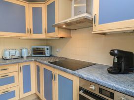 A kitchen with appliances including a kettle and microwave at 11 Berry Close Painswick