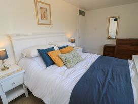 A bedroom with a bed and furniture at 11 Berry Close in Painswick