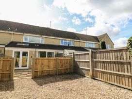 A backyard view with a gravel area and wooden fencing at 11 Berry Close in Painswick
