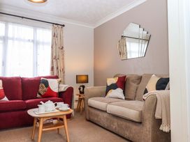 A living room with sofas and a coffee table at 16 Elmbank Gardens in Paignton