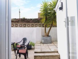 A garden with a table and chairs at 16 Elmbank Gardens in Paignton