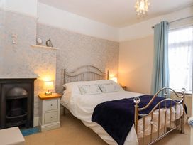 A bedroom with a bed and nightstands at 16 Elmbank Gardens in Paignton