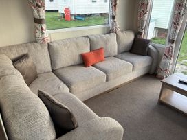 A living room with a sofa and coffee table at Harlyn Hideaway (Swift Barritz) Padstow