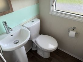 A bathroom with a sink and toilet at Harlyn Hideaway (Swift Barritz) Padstow