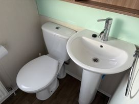 A bathroom with a toilet and sink at Harlyn Hideaway (Swift Barritz) Padstow