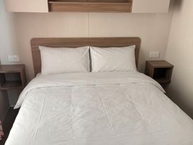 A bedroom with a double bed and bedside tables at Harlyn Hideaway (Swift Barritz) Padstow