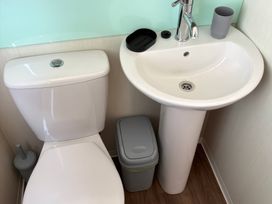 A bathroom with a toilet and sink at Harlyn Hideaway (Swift Barritz) Padstow