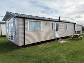 A mobile home with a picnic table outside at Harlyn Hideaway (Swift Barritz) Padstow
