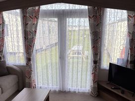 A living room with a window and sofa at Harlyn Hideaway (Swift Barritz) Padstow