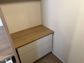 A storage area with a drawer unit and wooden surface at Harlyn Hideaway (Swift Barritz) Padstow