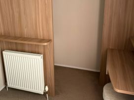 An office space with a radiator and a wooden desk at Harlyn Hideaway (Swift Barritz) Padstow