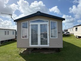 A holiday home with windows and a door at Harlyn Hideaway (Swift Barritz) Padstow