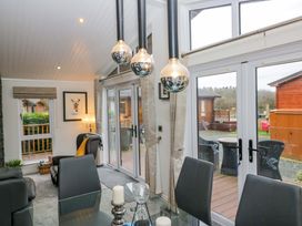 A dining room with a table and chairs at Waters Edge Lodge Windermere