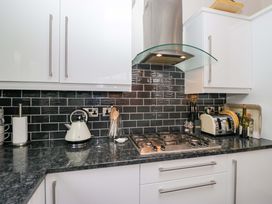 A kitchen with a kettle, gas hob, and toaster at Waters Edge Lodge Windermere