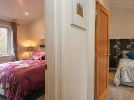 A bedroom with two beds and a window at Waters Edge Lodge in Windermere