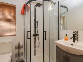 A bathroom with a shower and a sink at Waters Edge Lodge in Windermere