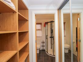 A bathroom with a shower and toilet at Waters Edge Lodge in Windermere