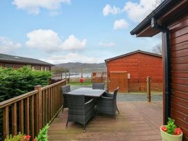 An outdoor dining area with a table and chairs at Waters Edge Lodge in Windermere