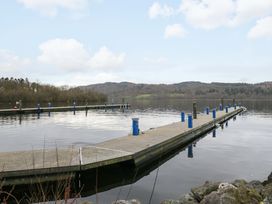 A dock with piers on water at Waters Edge Lodge Windermere
