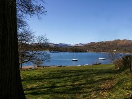 A view of a lake with boats and hills at Waters Edge Lodge Windermere