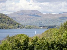 A view of a lake with mountains in the background at Waters Edge Lodge Windermere