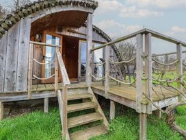 A wooden cabin with steps and deck at Vine View near Halesworth