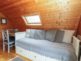 An attic room with a sofa and table at Vine View near Halesworth
