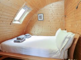 A bedroom with a bed and towels at Vine View near Halesworth