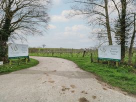 An entrance to Valley Farm Vineyards with signs showing Tours, Tastings, and Sales near Halesworth