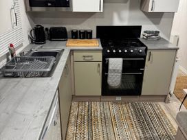 A kitchen with sink and cooking range at N5 in Ilfracombe