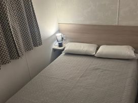 A bedroom with a bed and bedside lamp at N5 Ilfracombe