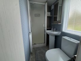 A bathroom with a shower, wash basin, and toilet at N5 in Ilfracombe