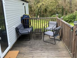 A seating area with chairs and a table on a deck at N5 in Ilfracombe