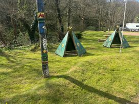 An outdoor area with tents and a totem pole at N5 Ilfracombe