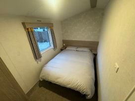 A bedroom with a bed and window at N5 Ilfracombe