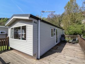 A cabin with a deck and chairs at N5 Ilfracombe