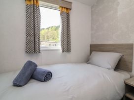A bedroom with a bed and towels at N5 in Ilfracombe