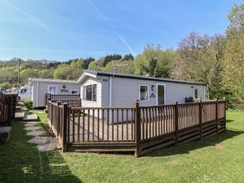 A cabin with deck and fence at N5 Ilfracombe