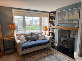 A living room with a sofa and fireplace at York Cottage in Southwold